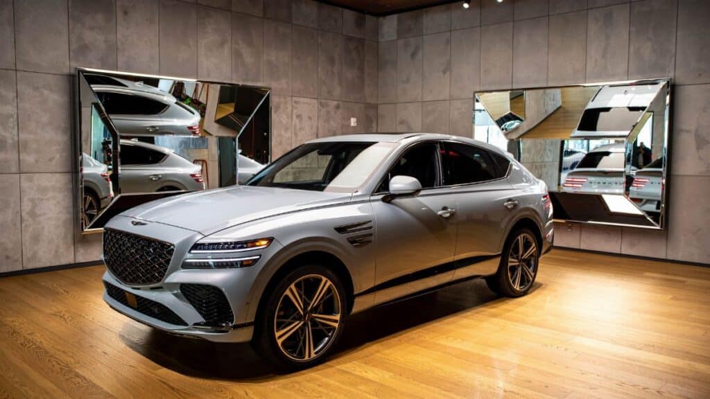 Sleek luxury SUV displayed in a modern indoor car showroom in New York City.