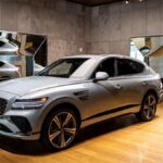 Sleek luxury SUV displayed in a modern indoor car showroom in New York City.