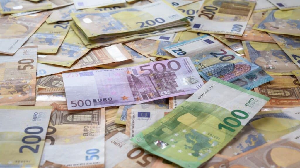 A collection of Euro banknotes representing wealth, savings, and European economy.