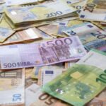 A collection of Euro banknotes representing wealth, savings, and European economy.