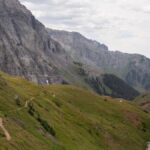 Explore the breathtaking mountain trail leading to an alpine lake in Colorado's rugged landscape.