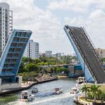 A beautiful view of a drawbridge raised in Miami, Florida, showcasing urban architecture and waterway traffic.