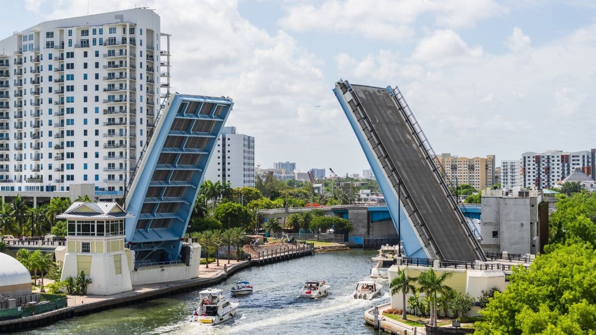 A beautiful view of a drawbridge raised in Miami, Florida, showcasing urban architecture and waterway traffic.