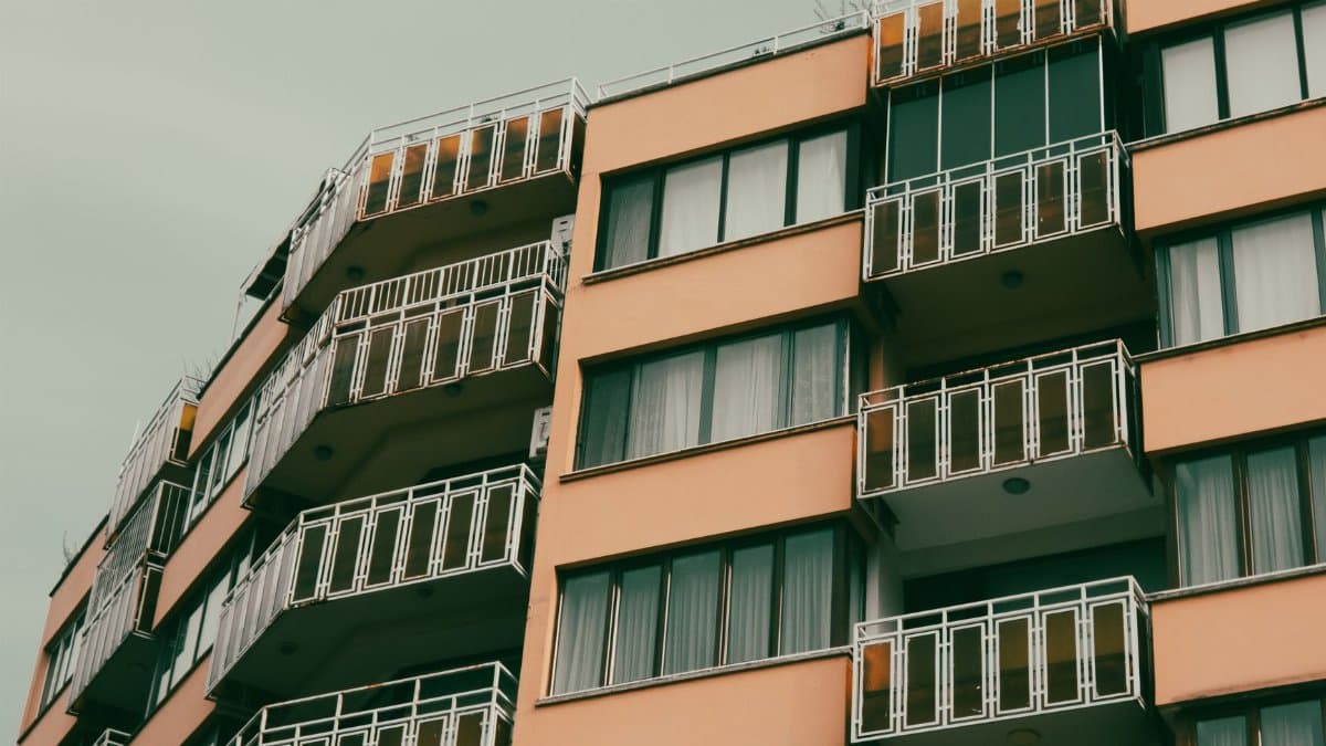 A contemporary apartment building with balconies in an urban setting.