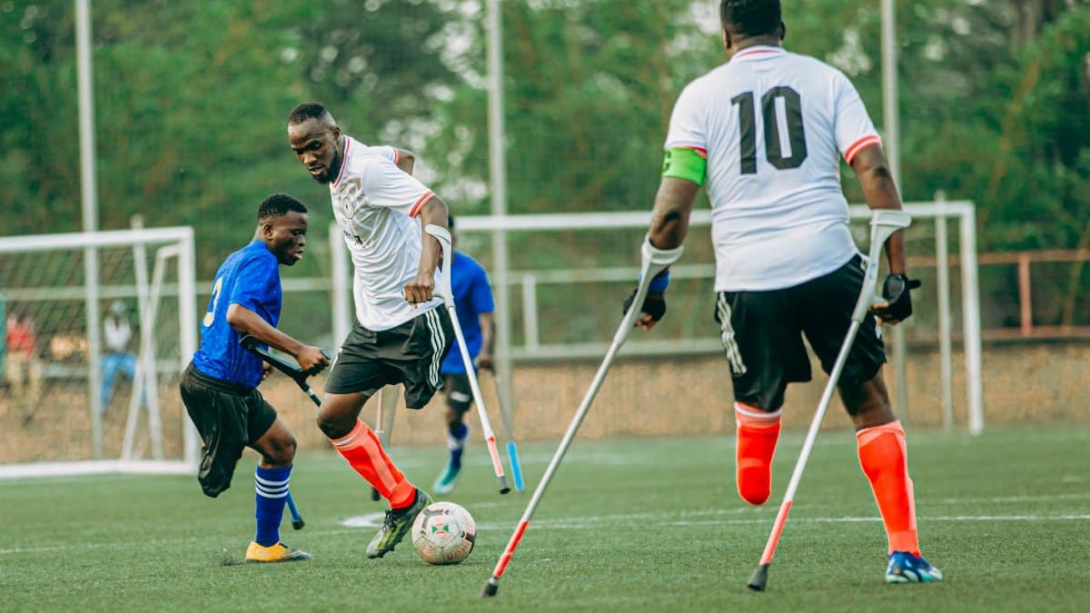 Energetic amputee soccer match highlighting skill and determination.