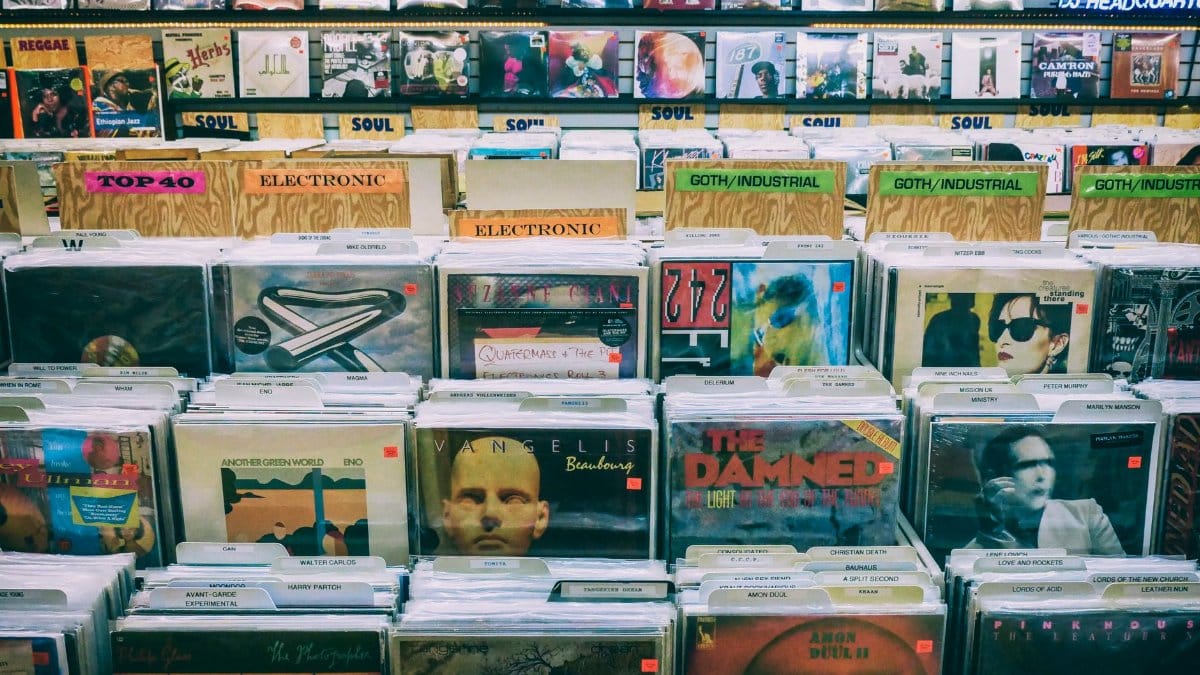 A vintage vinyl record display with diverse music genres in a classic music store.