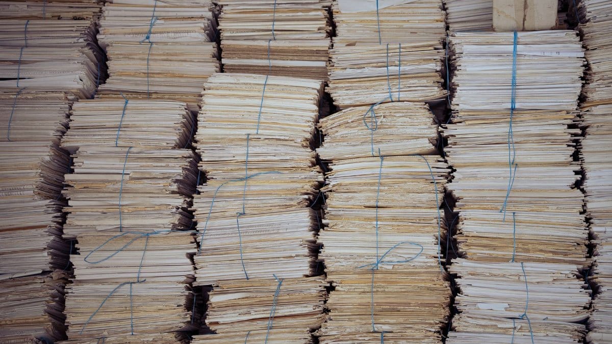High stacks of organized, bound paper bundles create a structured and neat appearance.