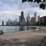 View of Chicago skyline with Lake Michigan from North Avenue Beach on a cloudy day.