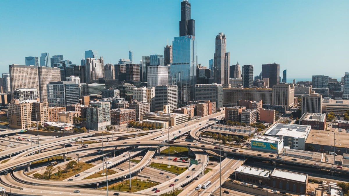 Aerial perspective of Chicago cityscape featuring Willis Tower on a sunny day.