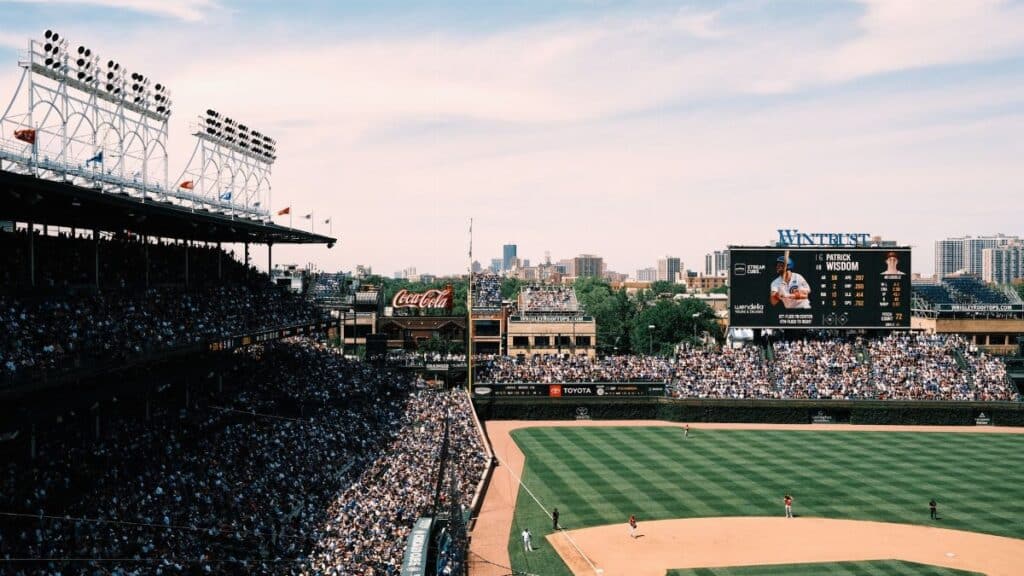Aerial shot of a crowded baseball game at Wrigley Field, showcasing the vibrant cityscape of Chicago.