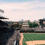 Aerial shot of a crowded baseball game at Wrigley Field, showcasing the vibrant cityscape of Chicago.