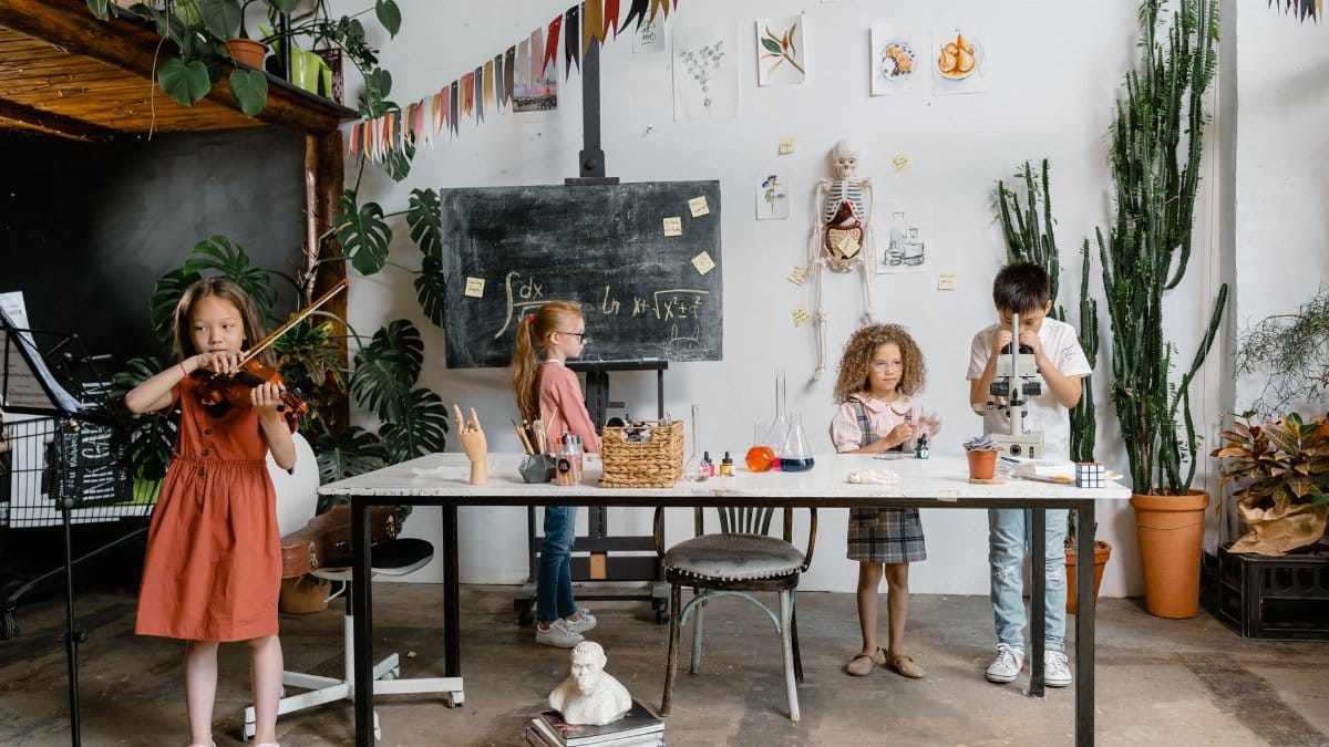 Children engaged in creative learning with music, science, and art in a vibrant classroom setting.