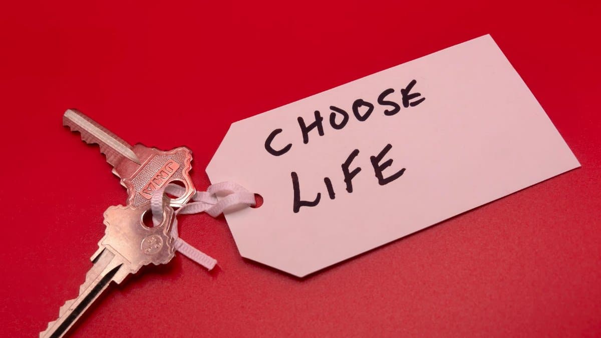 Keys on a red background with a 'Choose Life' tag, symbolizing decision-making.