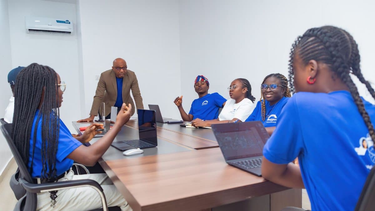 A diverse group of adults collaborating during a business meeting in a modern office setting.