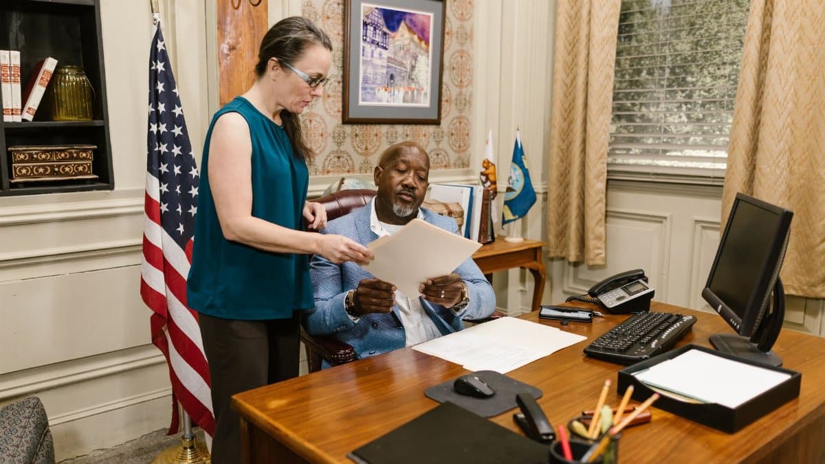 A lawyer and client discuss legal documents in a law office setting, highlighting professionalism and collaboration.