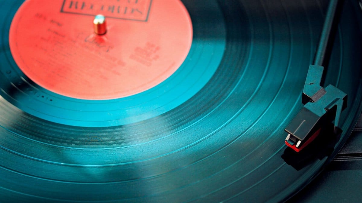 A detailed close-up view of a vintage vinyl record spinning on a turntable, capturing its nostalgic beauty.