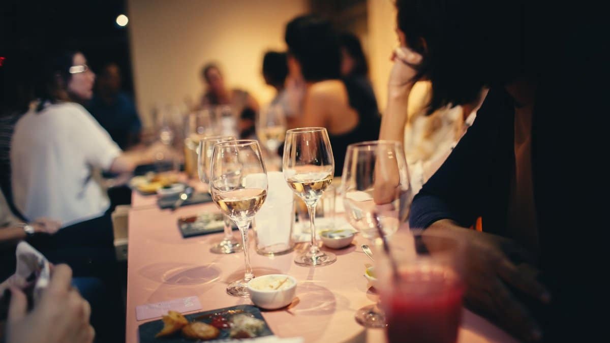A lively indoor gathering with people enjoying drinks and conversation in a Brazilian restaurant.