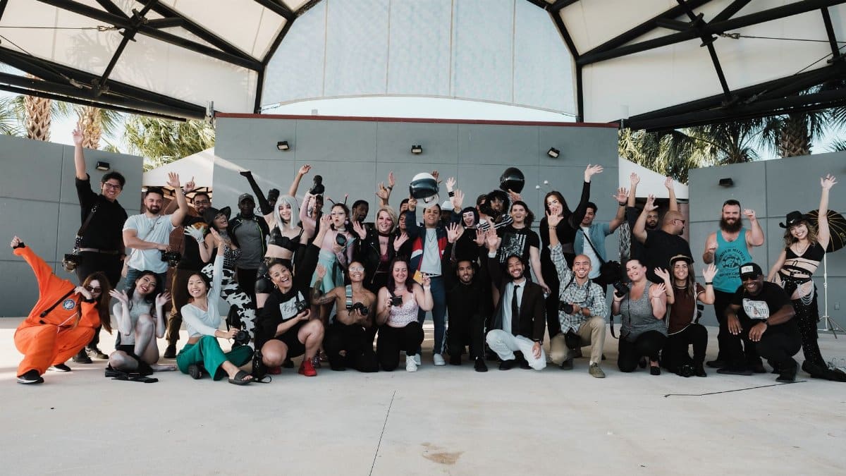 A diverse and joyful group of adults celebrating at an outdoor event venue.