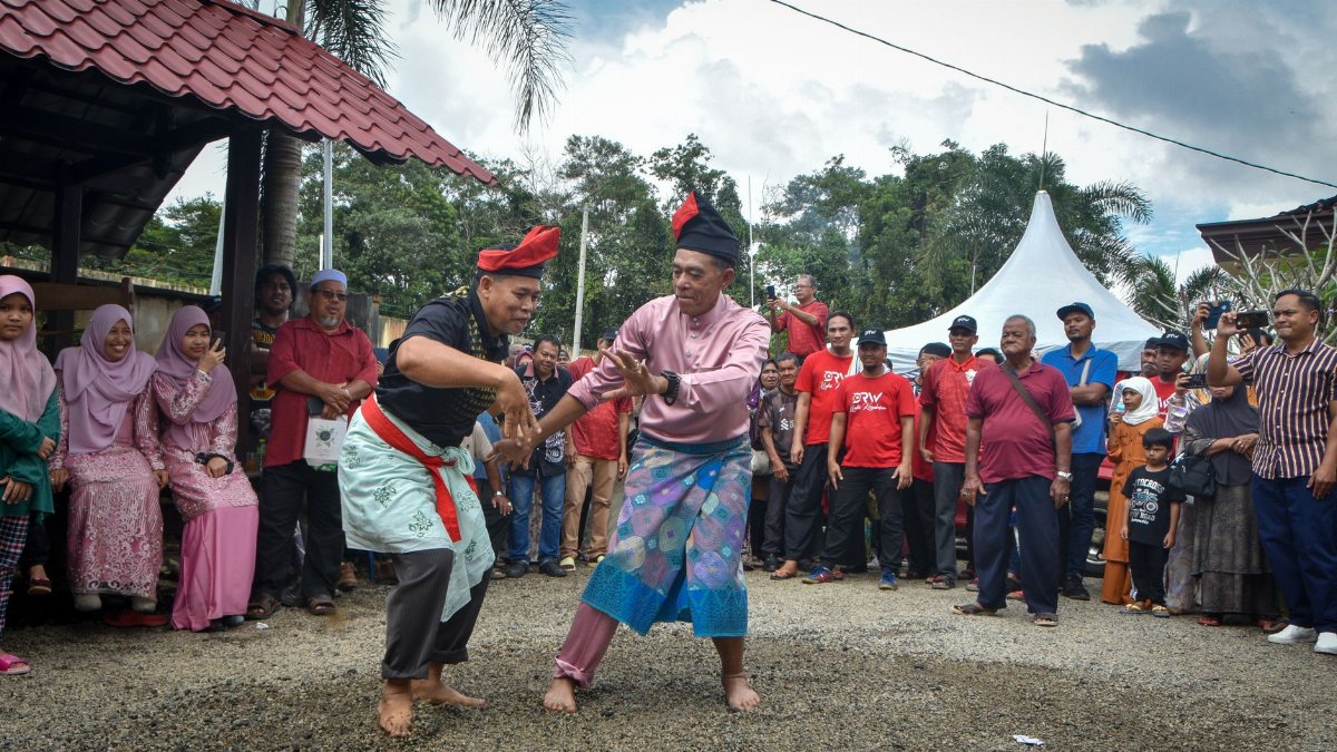 A lively outdoor cultural celebration with traditional dance and vibrant attire.