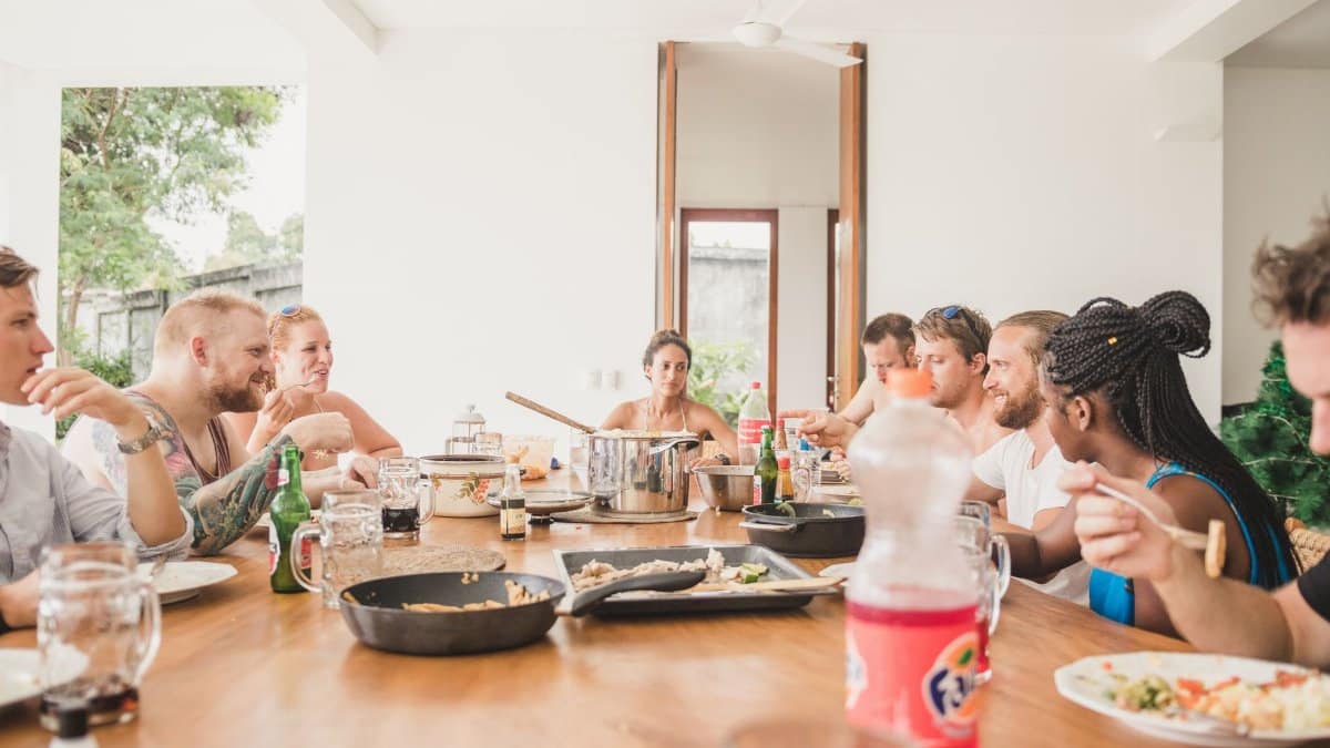 A diverse group of adults enjoying a meal together at a table in Bali, Indonesia.