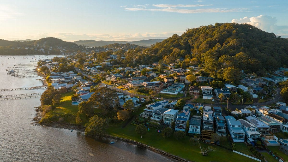 Scenic aerial view of a coastal town with houses by the waterfront in Gosford, NSW, Australia.