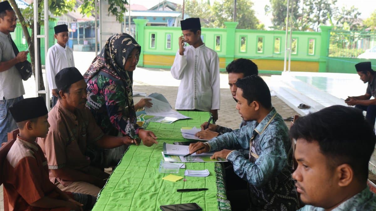People gathered outdoors for voting registration, engaging in community participation.