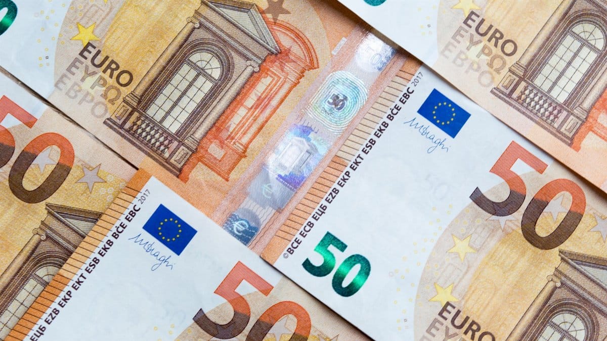 Detailed close-up of multiple overlapping euro banknotes depicting currency and finance themes.
