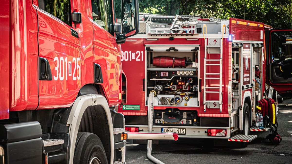 Fire trucks in action on a sunny day in Wrocław, Poland.