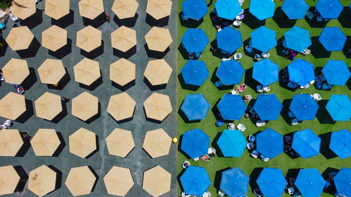 Aerial shot of yellow and blue parasols in Holon, Israel, creating a vibrant summer scene.
