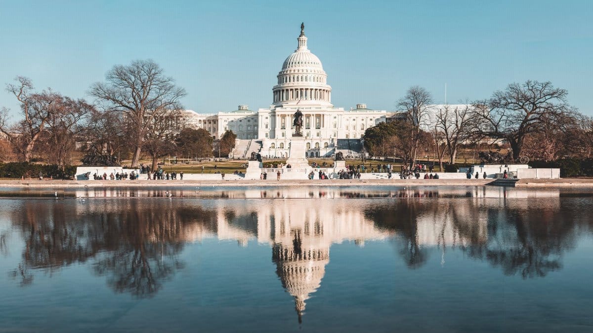Stunning reflection of the United States Capitol in a tranquil pool on a clear autumn day.