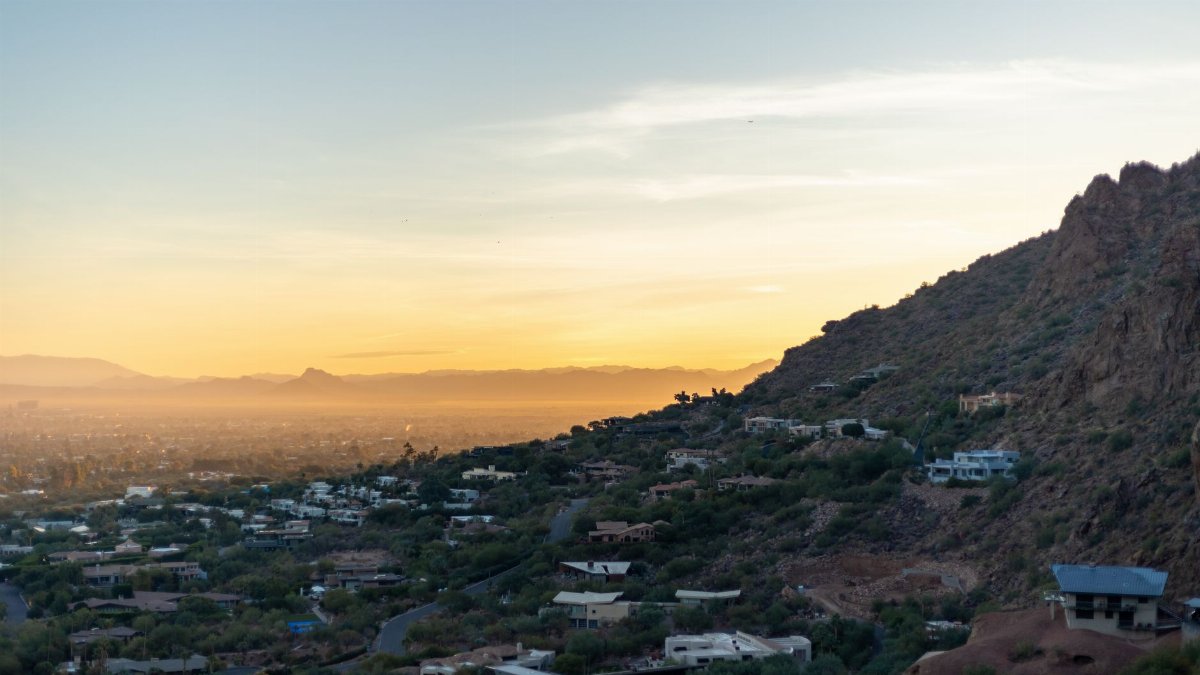 Beautiful landscape view of Phoenix, Arizona during sunset with cityscape and desert hills.