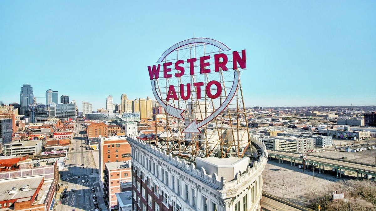 Iconic Western Auto sign atop a historic building in Kansas City skyline.