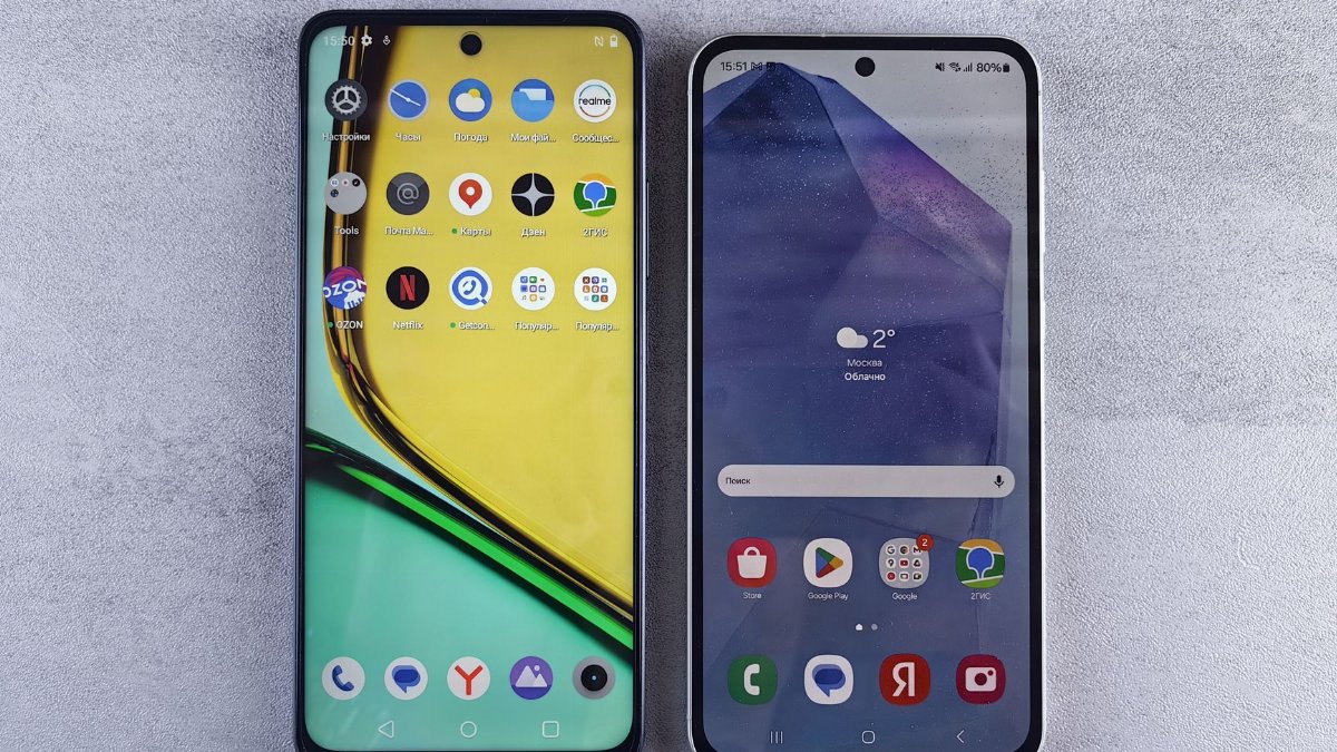 Top-down view of two modern smartphones with home screens displayed on a textured surface.