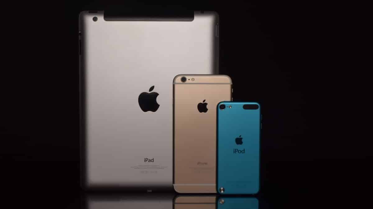 Elegant display of Apple devices including iPad, iPhone, and iPod against a black background.