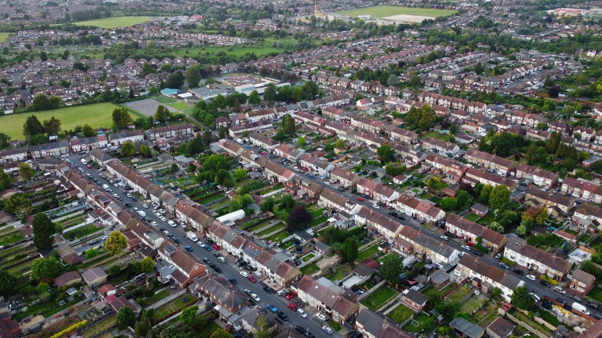 Aerial view of a suburban neighborhood in Luton, England, UK showcasing rows of homes and greenery.