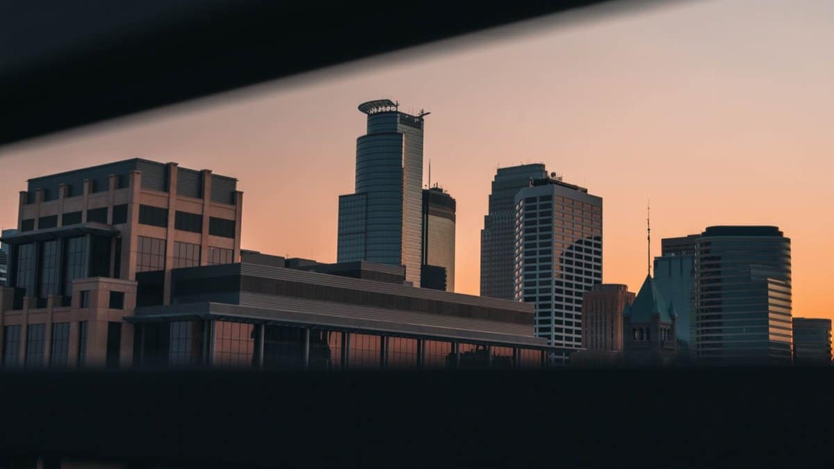 Captivating view of Minneapolis skyline during sunset, showcasing modern architecture in a serene twilight.