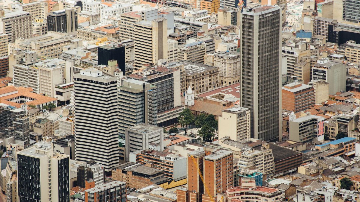 Aerial cityscape of downtown Bogotá featuring modern skyscrapers and urban architecture.