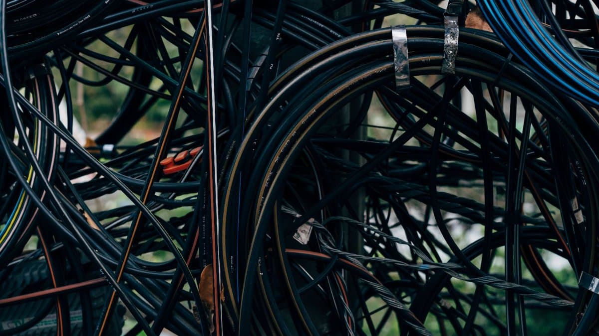 Close-up view of a complex tangle of electrical wires outdoors.