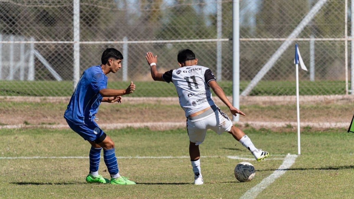 Two soccer players in action during a match near the corner flag on a sunny day.