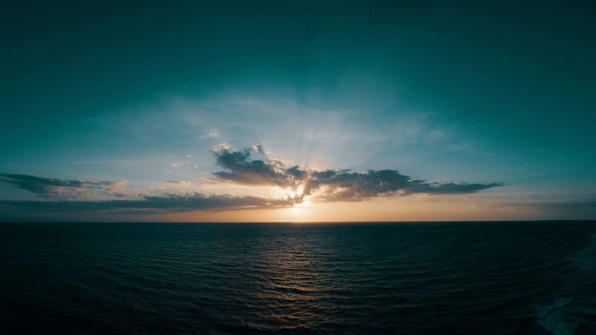 Stunning sunset over the Gulf of Mexico with dramatic sky and ocean view, capturing tranquility and beauty.