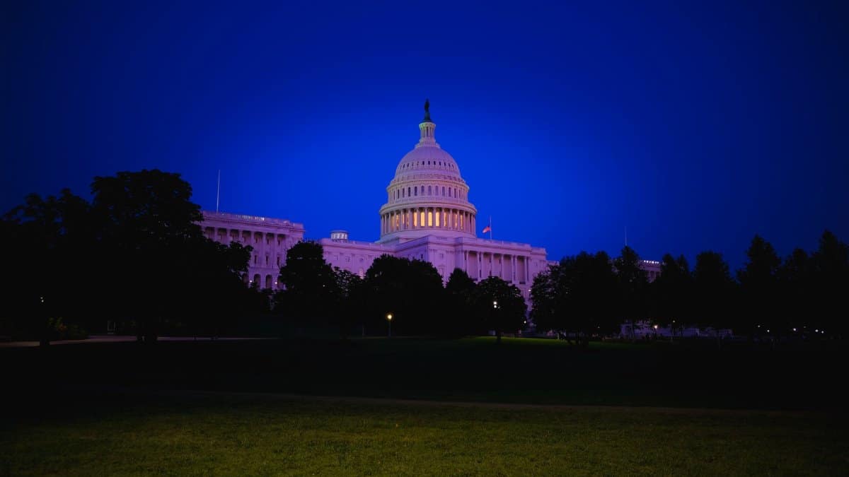 A stunning view of the US Capitol Building illuminated at twilight, showcasing its iconic dome and neoclassical architecture.
