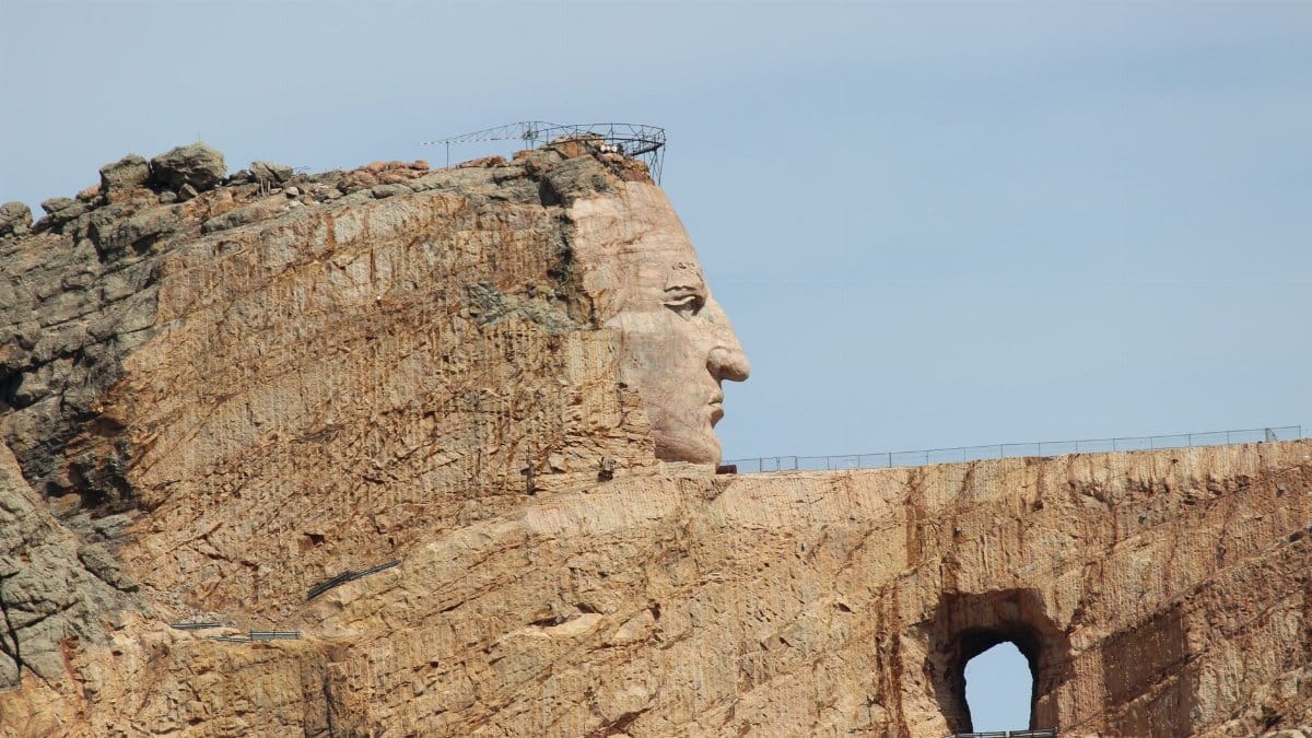 Side view of the Crazy Horse Memorial carved into rock in South Dakota, USA.