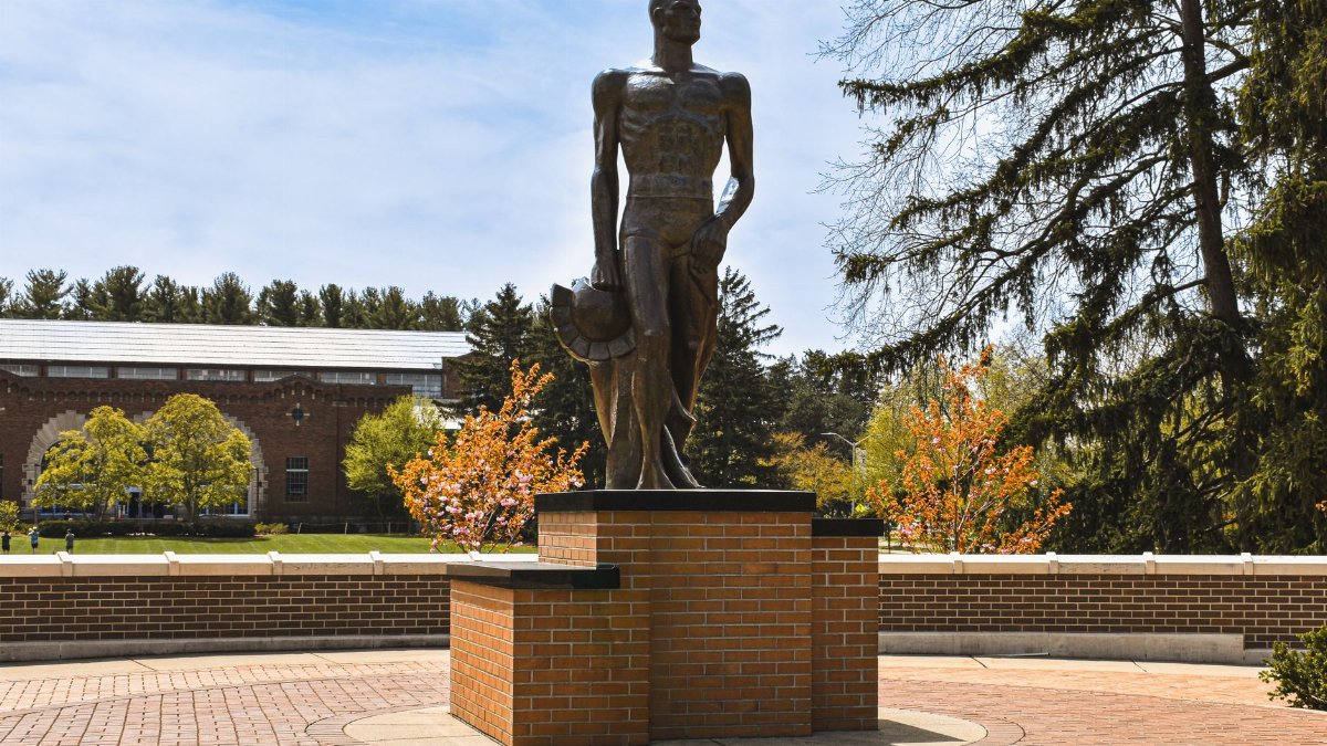 Bronze Spartan statue under a clear spring sky on Michigan State University campus, East Lansing.