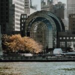 Elegant cityscape featuring modern waterfront buildings and a marina in an urban setting.