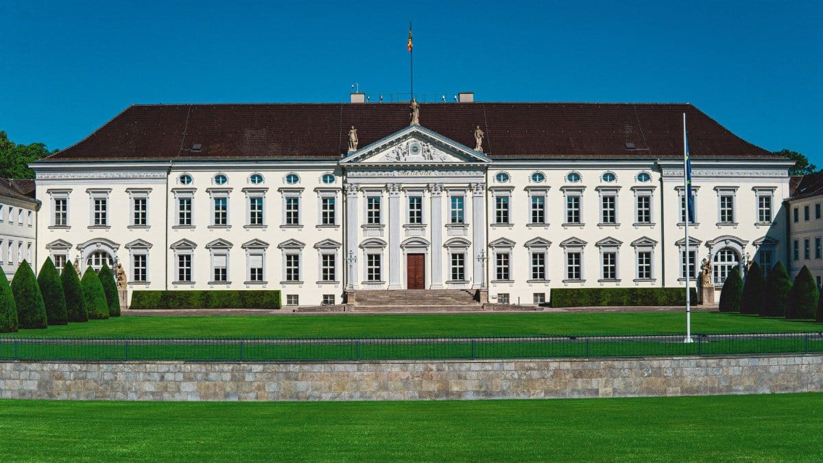 Front view of Bellevue Palace in Berlin, showcasing its historic architecture under a clear blue sky.