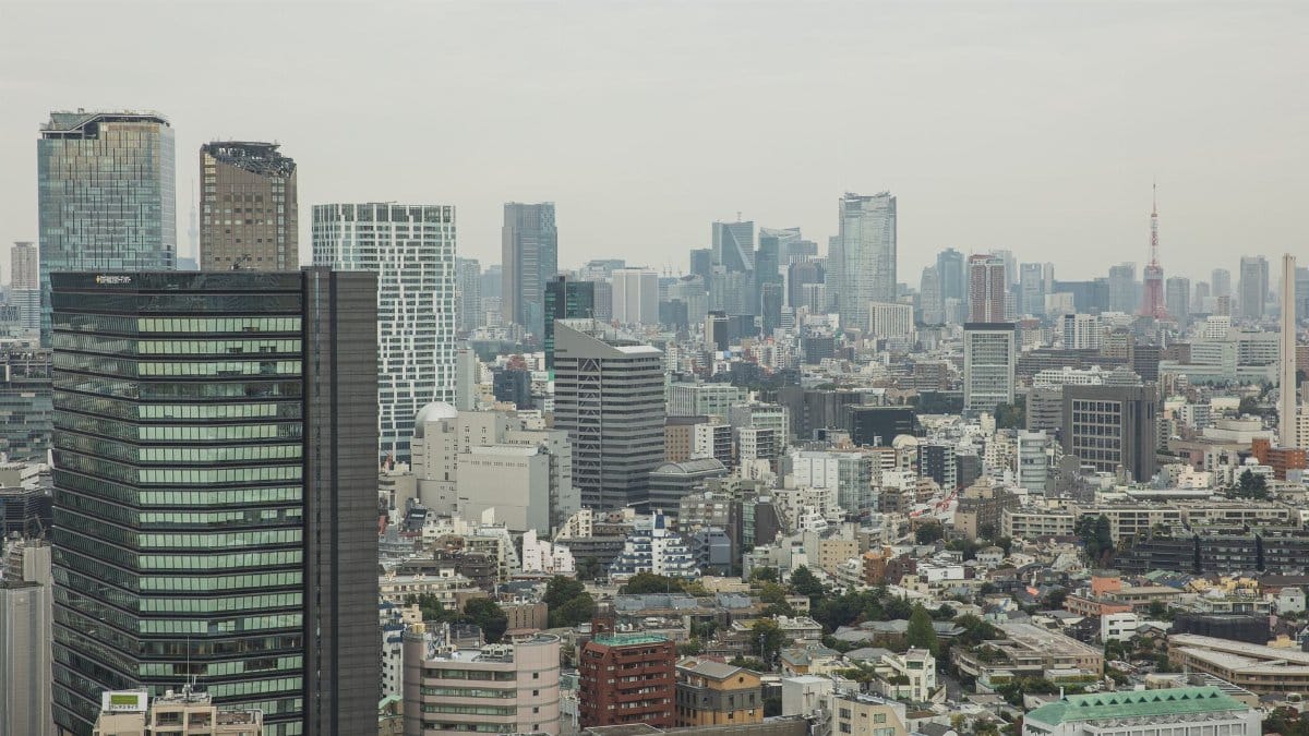 Aerial view of modern city with glass skyscrapers and multistory buildings in overcast weather
