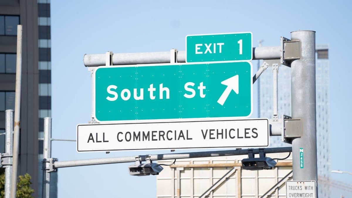 Green street sign for South Street and exit 1, directing all commercial vehicles.
