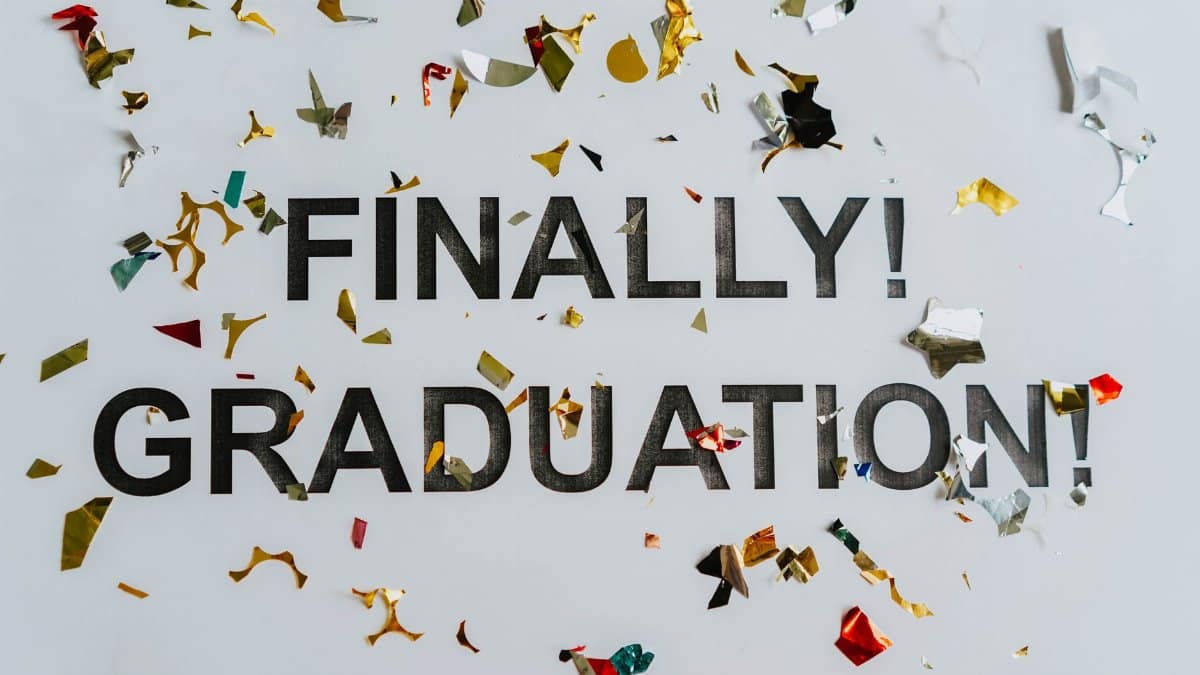 Colorful confetti surrounds 'FINALLY! GRADUATION!' signifying celebration and achievement.