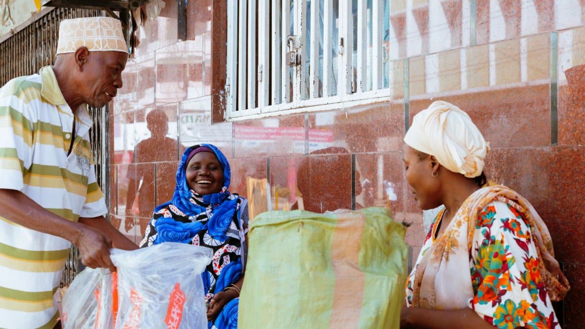 Cheerful street scene showing vibrant interaction among people at a local market.