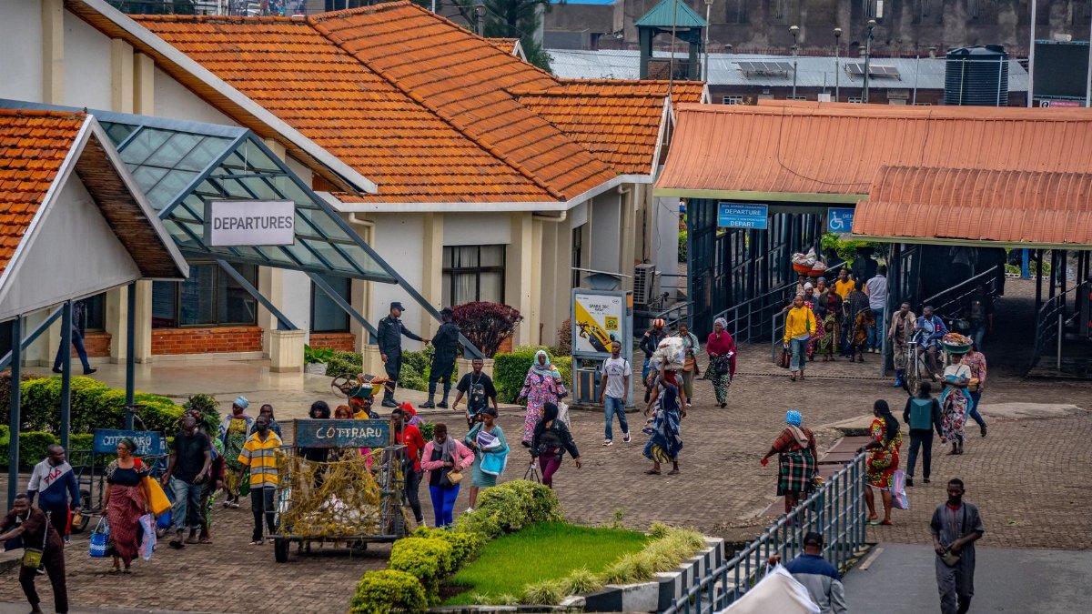 Vibrant African bus terminal bustling with people heading to departures, showcasing daily commute lifestyle.
